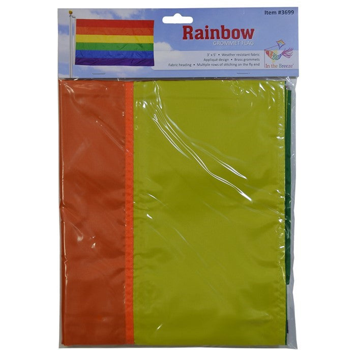 Rainbow 3x5 Grommet Flag featuring bright colors and brass grommets displayed on an outdoor flag pole against a clear blue sky.