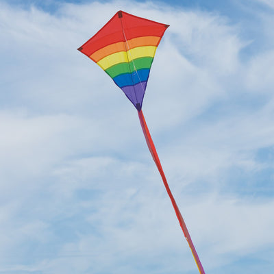 Rainbow Arch 27-Inch Diamond Kite displaying colorful arcs in the sky, ready for flying on a bright day outdoors.