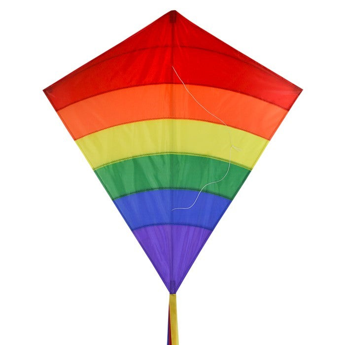 Rainbow Arch 39-Inch Diamond Kite in vibrant colors, featuring long fabric tails, soaring against a bright blue sky on a sunny day.