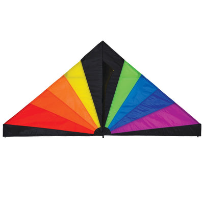 Rainbow Black 70 inch Delta kite with vibrant rainbow colors flying in a clear blue sky at a park.