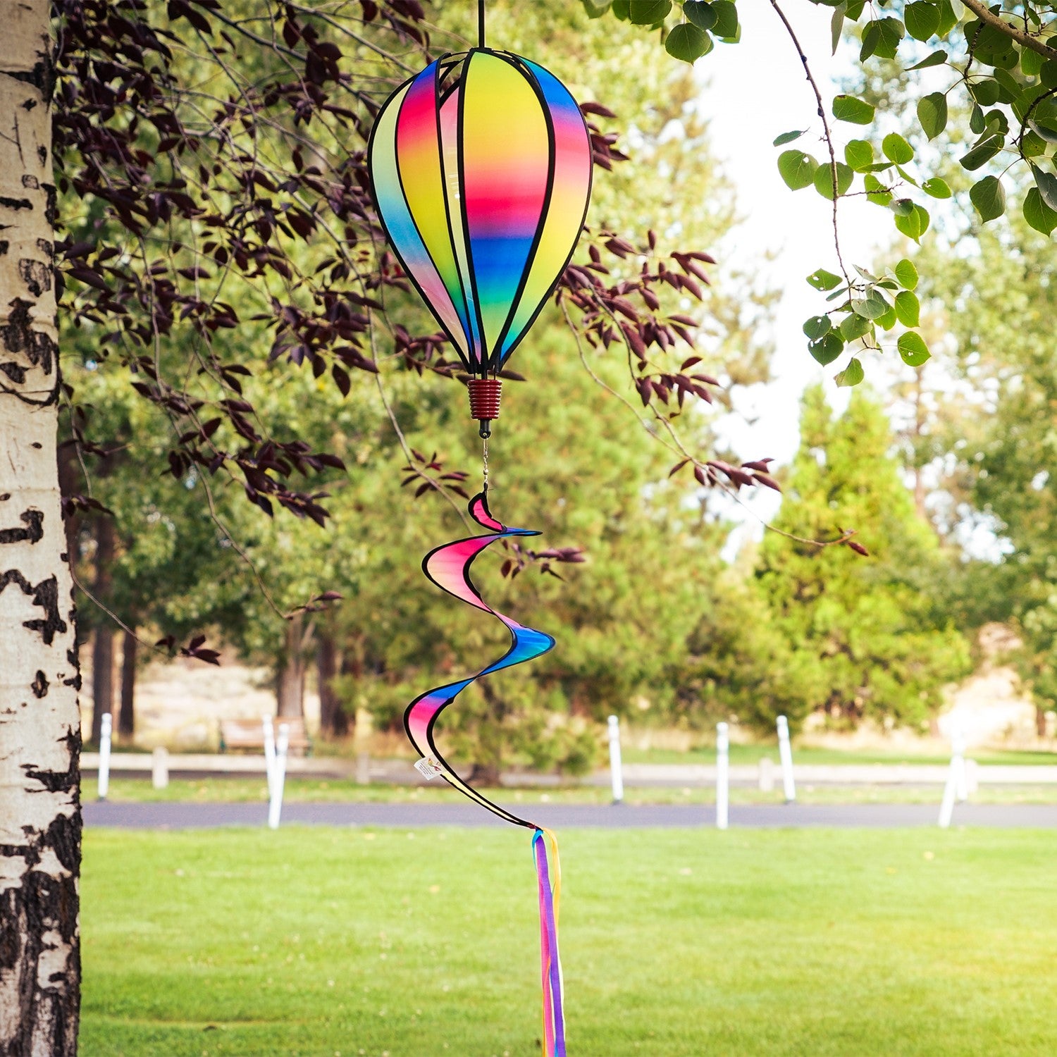 Rainbow Blended Hot Air Balloon with blended colorful panels, twister tail, and clear plastic accents displayed in an outdoor setting.