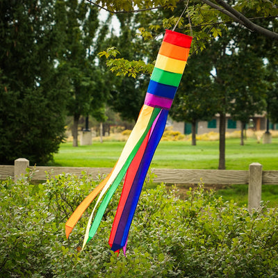 Rainbow Column 50" windsock featuring vibrant rainbow hues and six matching tails, displayed elegantly in a garden setting.