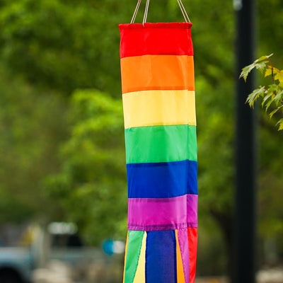 Rainbow Column 50" windsock featuring vibrant rainbow hues and six matching tails, displayed elegantly in a garden setting.