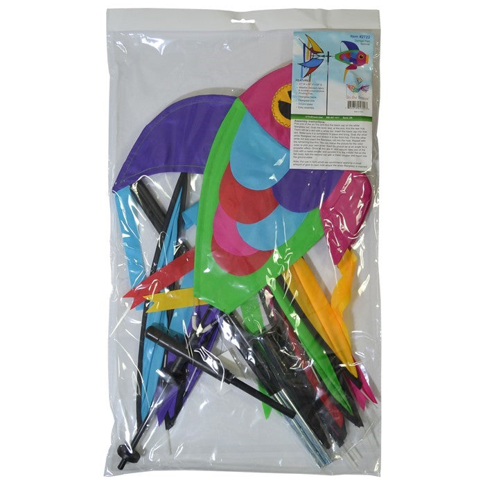 Rainbow Damselfish Spinner featuring vivid rainbow colors in a garden, spinning gracefully atop a fiberglass pole.