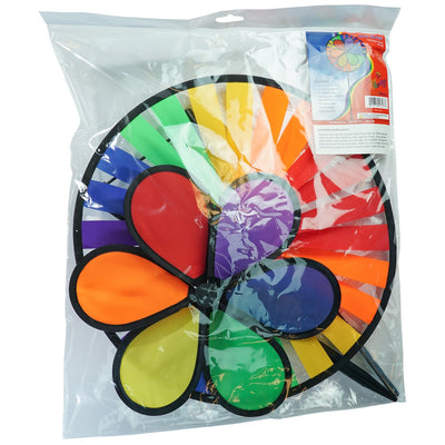 Rainbow Dazy Wheel garden spinner featuring a colorful design with a 12-inch petal top and a 15-inch spinner wheel, displayed outdoors.