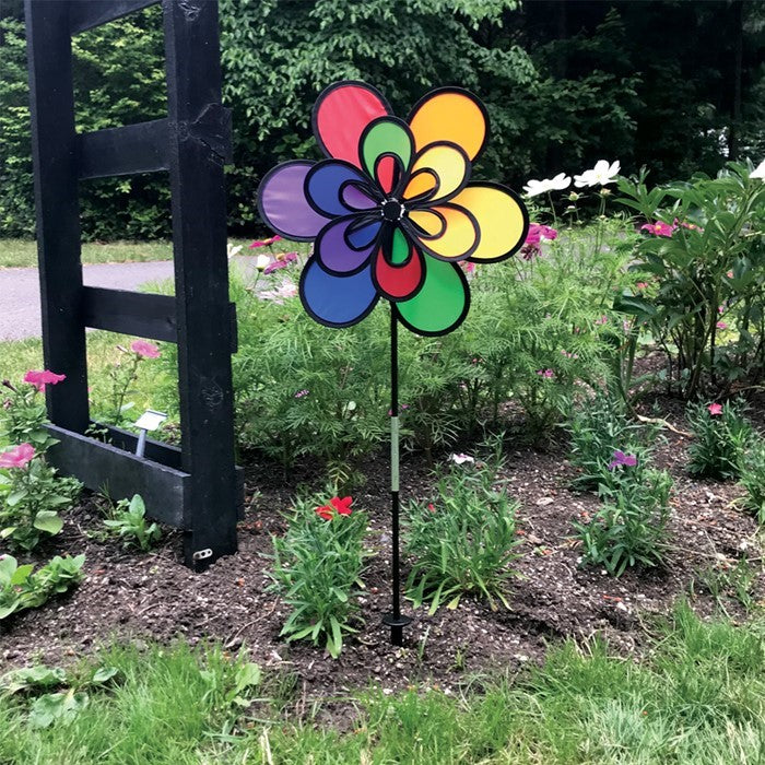 15-inch Rainbow Double Windee Wheelz garden spinner displaying vibrant colors in rotation, supported by a sturdy fiberglass pole and stake.
