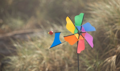 Rainbow Flower Windmill Ground Spinner featuring a colorful flower design, crafted from durable materials, spinning elegantly in the garden.