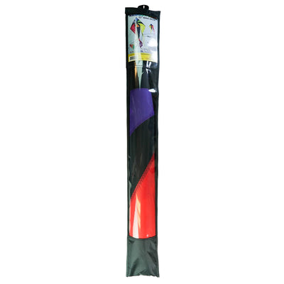 Rainbow Flux 52 inch Wave Delta Kite in vibrant rainbow colors seen soaring in a clear blue sky against a backdrop of grassy outdoors.