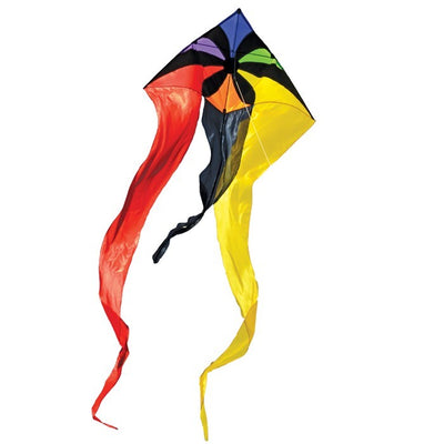 Rainbow Flux 52 inch Wave Delta Kite in vibrant rainbow colors seen soaring in a clear blue sky against a backdrop of grassy outdoors.