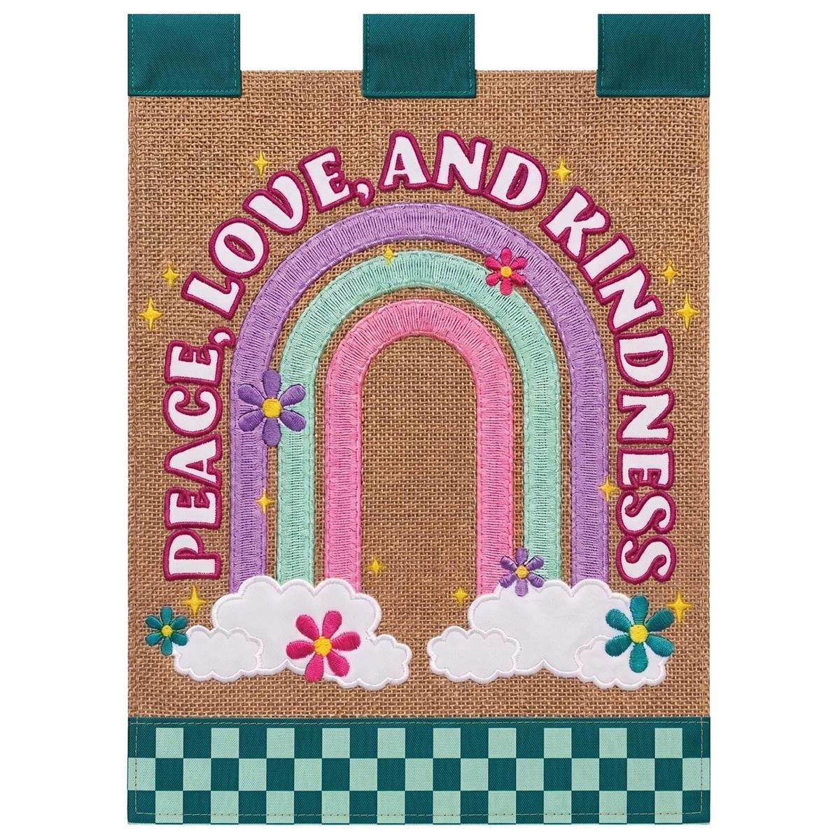 Rainbow Peace Love Kindness garden flag featuring vibrant colors and intricate appliqued design displayed on a flagpole in a lush garden.