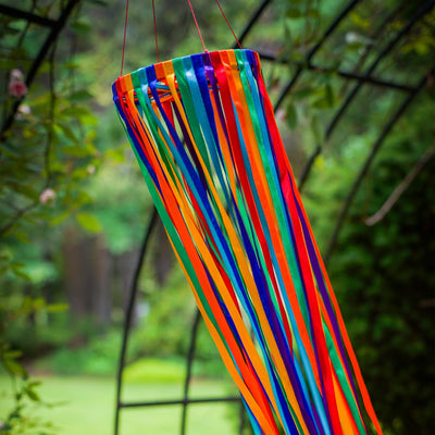 The Rainbow Ribbon Windsock features an array of shiny satin ribbons in vibrant colors, beautifully arranged around a 4.5-inch hoop, ideal for outdoor decoration.