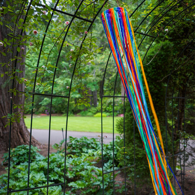 The Rainbow Ribbon Windsock features an array of shiny satin ribbons in vibrant colors, beautifully arranged around a 4.5-inch hoop, ideal for outdoor decoration.