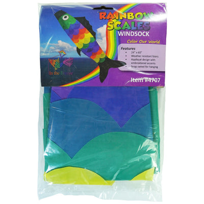 Rainbow Scales Fishsock, a colorful and whimsical windsock with detailed applique, displayed in an outdoor garden setting, showcasing its design.