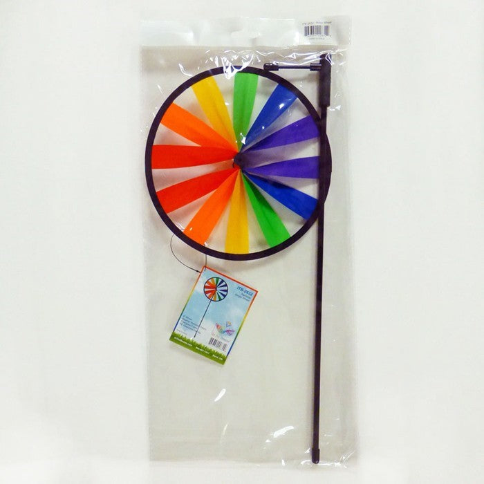 Rainbow Single Wheel Spinner with bright colors spinning in a garden, showcasing its vibrant 8-inch design mounted on a sturdy fiberglass stem.