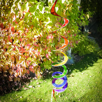 Rainbow Sparkle Curlie outdoor garden decor with vibrant colors, 48 inches long, swaying in the wind against a sunny background.
