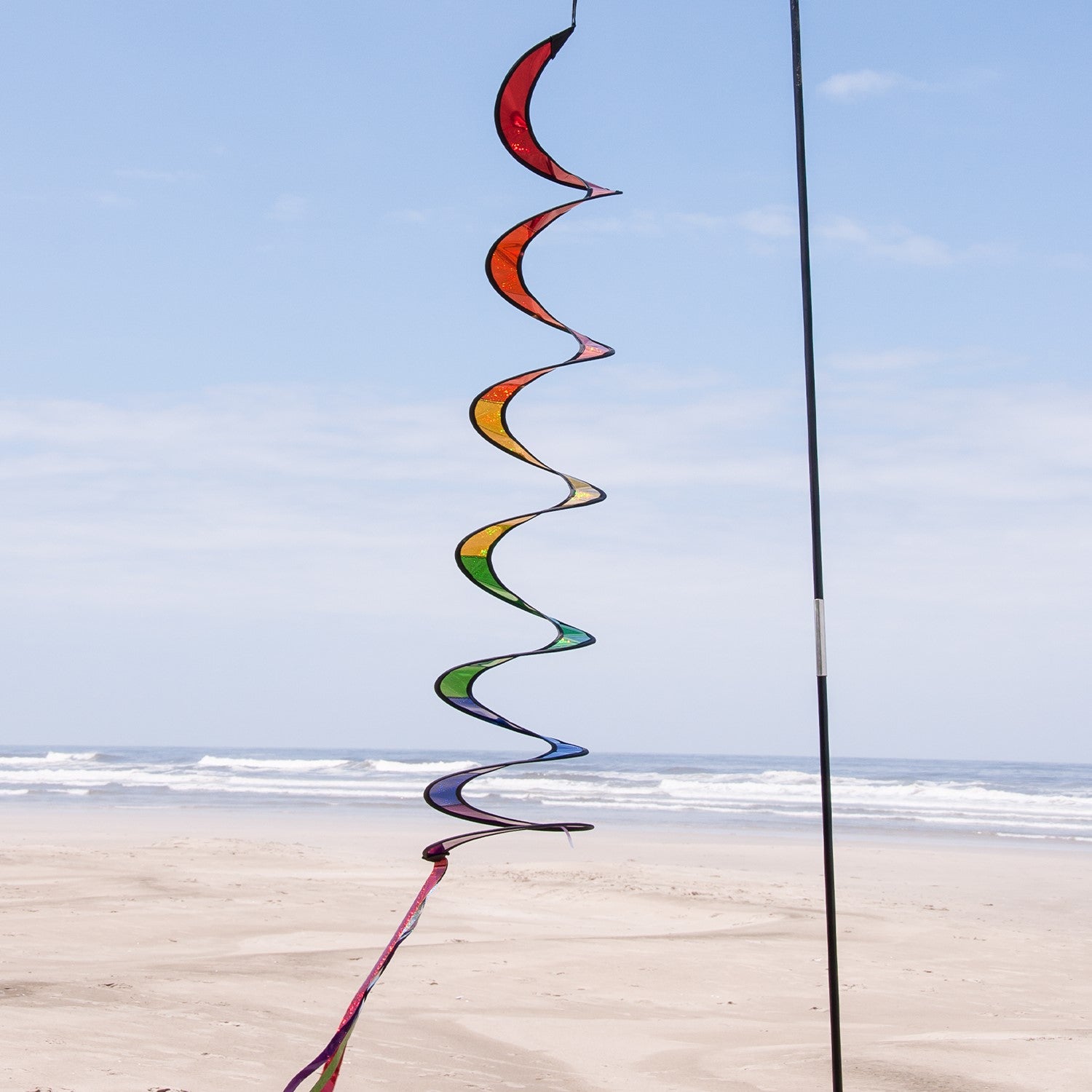 Rainbow Sparkle Curlie outdoor garden decor with vibrant colors, 48 inches long, swaying in the wind against a sunny background.