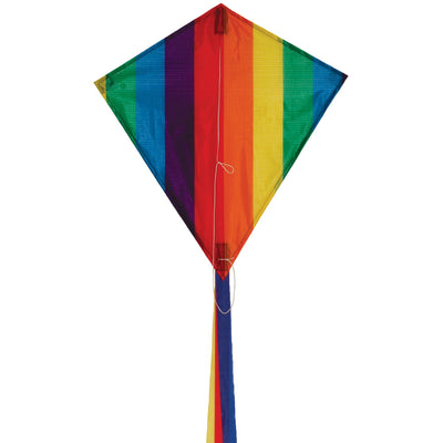 Rainbow Stripe 18" Diamond Kite flying high against a blue sky with colorful tails trailing behind, showcasing its vibrant spectrum design and classic shape.