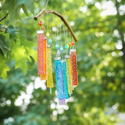 Rainbow Textured Glass Mobile Wind Chime with colorful glass panels and wooden hanging bar, displayed outdoors catching sunlight.