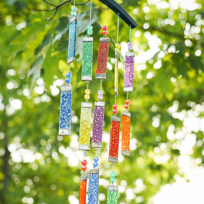 Rainbow Textured Tiered Glass Mobile Wind Chime featuring vibrant glass pieces and beads hanging in sunlight, creating a colorful display outdoors.