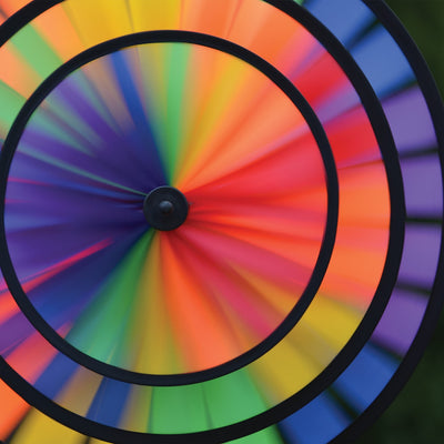 Rainbow Triple Wheel Spinner made with colorful wheels and sturdy fiberglass frame, beautifully spinning outdoors for garden charm and fun.