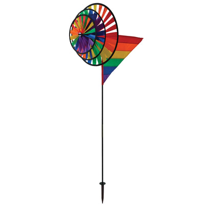 Rainbow Wind Sail Triple Wheel Spinner showcasing three spinning wheels in a rainbow spectrum, set against a clear blue sky with a pivoting pole for wind display.