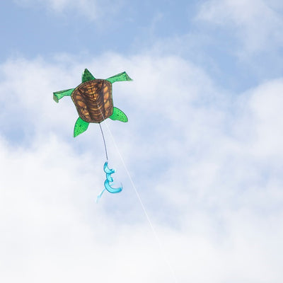 Realistic Sea Turtle Kite soaring in the sky, featuring vivid detailed design, durable frame, and twister tail, captivating outdoor enthusiasts.