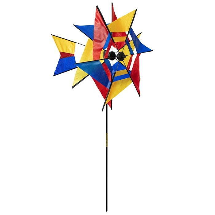 Red, Blue, and Yellow Kaleidoscope Ground Spinner elegantly incorporates a kaleidoscope sail design that spins with the wind, perfect for garden display.
