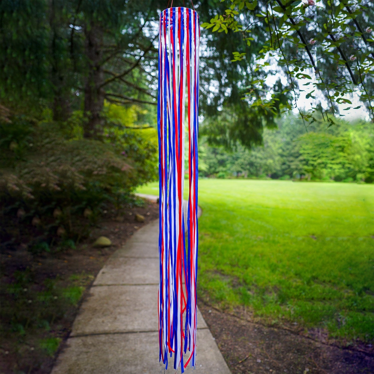 39\" Red, White & Blue Ribbon Windsock showcasing shiny satin ribbons in a festive garden setting, enhancing outdoor patriotic decor.