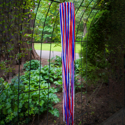 39\" Red, White & Blue Ribbon Windsock showcasing shiny satin ribbons in a festive garden setting, enhancing outdoor patriotic decor.