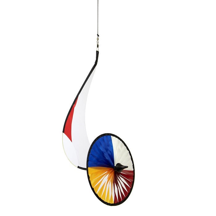 Red, White, Blue, and Yellow Flying Runner garden decoration, featuring an 8-inch spinning wheel, displayed gracefully in a flower garden.