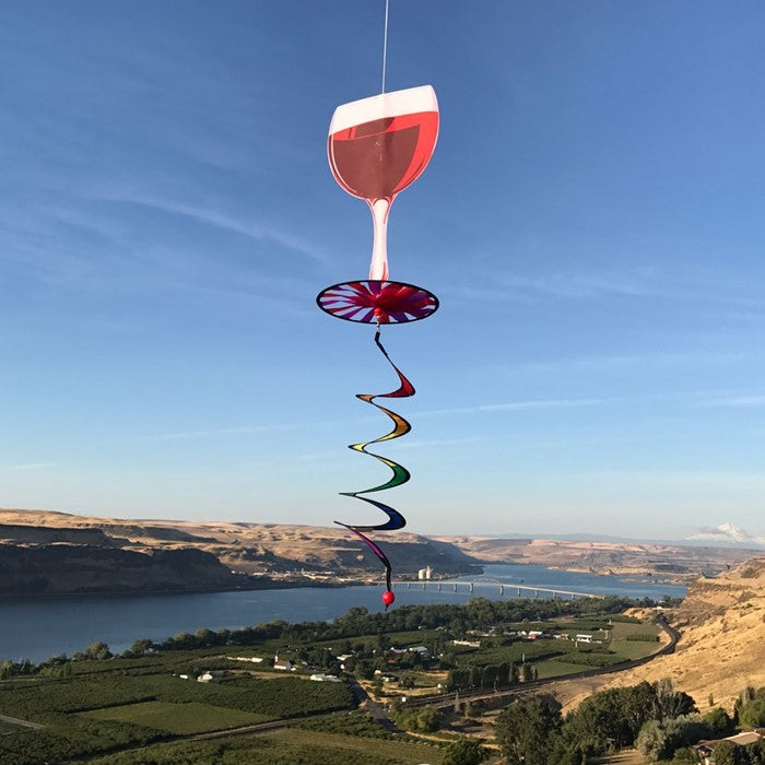 Red Wine 5 O'Clock Spinner featuring an 8-inch colorful design that replicates a red wine glass, spinning gracefully with a curlie tail for outdoor decor.