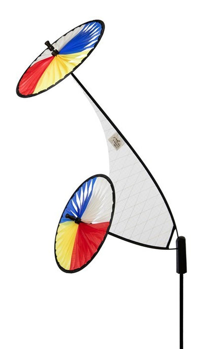 Red, Yellow, Blue & White Space Flower Ground Spinner in motion, featuring two colorful wheels on a sturdy pole in a garden setting.