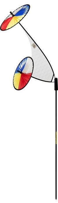 Red, Yellow, Blue & White Space Flower Ground Spinner in motion, featuring two colorful wheels on a sturdy pole in a garden setting.