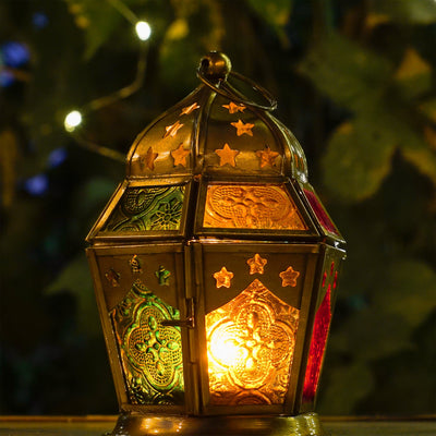 Red, Yellow & Green Hex Glass Tealight Lantern showcasing intricate patterned glass in a hexagonal shape, hanging outdoors creating ambient light.