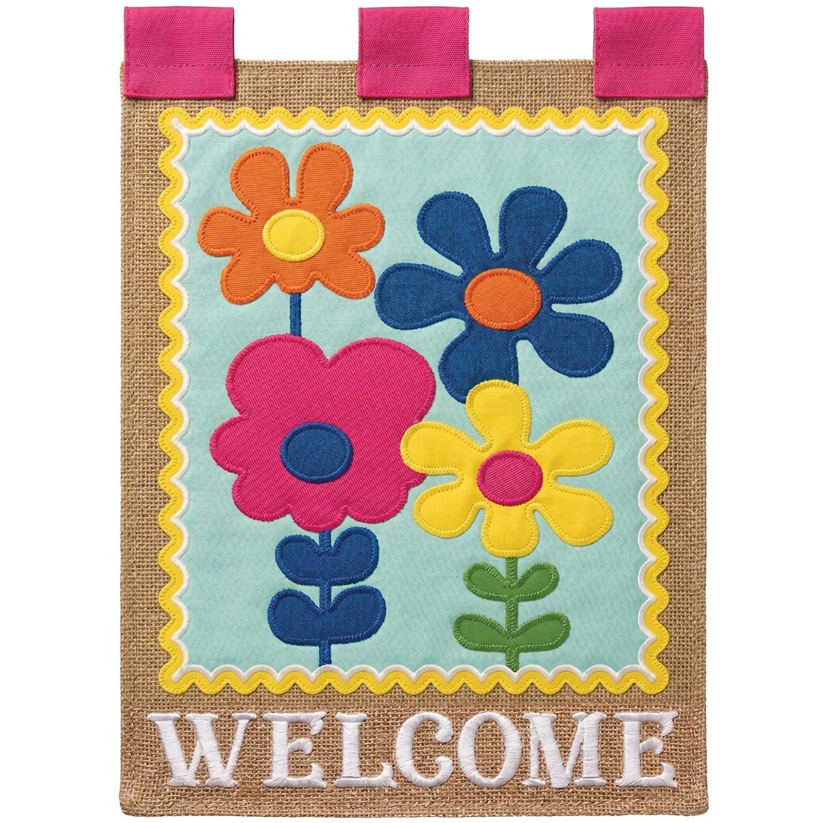 Retro Flowers Welcome Garden Flag featuring vibrant floral designs and intricate embroidery displayed outdoors on a garden pole.
