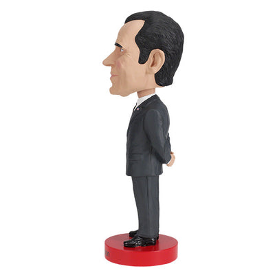 Richard Nixon bobblehead standing 8 inches tall, hand-painted with intricate details, displayed on a shelf against a neutral background.