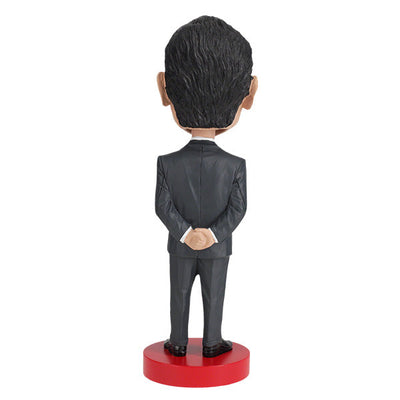 Richard Nixon bobblehead standing 8 inches tall, hand-painted with intricate details, displayed on a shelf against a neutral background.