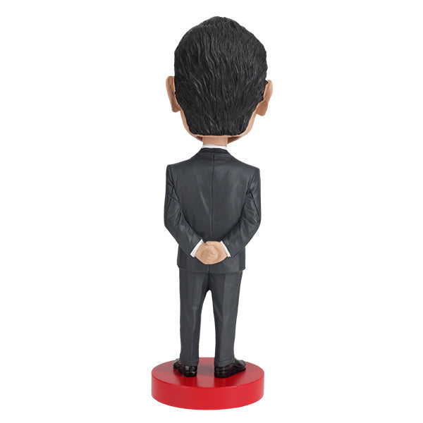 Richard Nixon bobblehead standing 8 inches tall, hand-painted with intricate details, displayed on a shelf against a neutral background.
