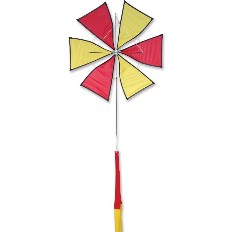 Roto Kite - Red with a spinning propeller design soaring in a clear blue sky, showcasing its vibrant colors and unique flight pattern.