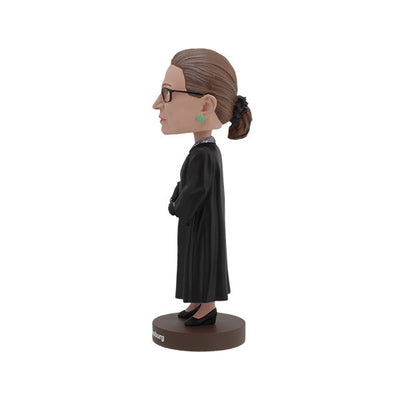 Ruth Bader Ginsburg bobblehead featuring her signature black robe, glasses, and earrings, displayed on a shelf as a tribute to her legacy.