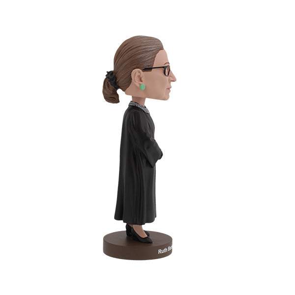 Ruth Bader Ginsburg bobblehead featuring her signature black robe, glasses, and earrings, displayed on a shelf as a tribute to her legacy.