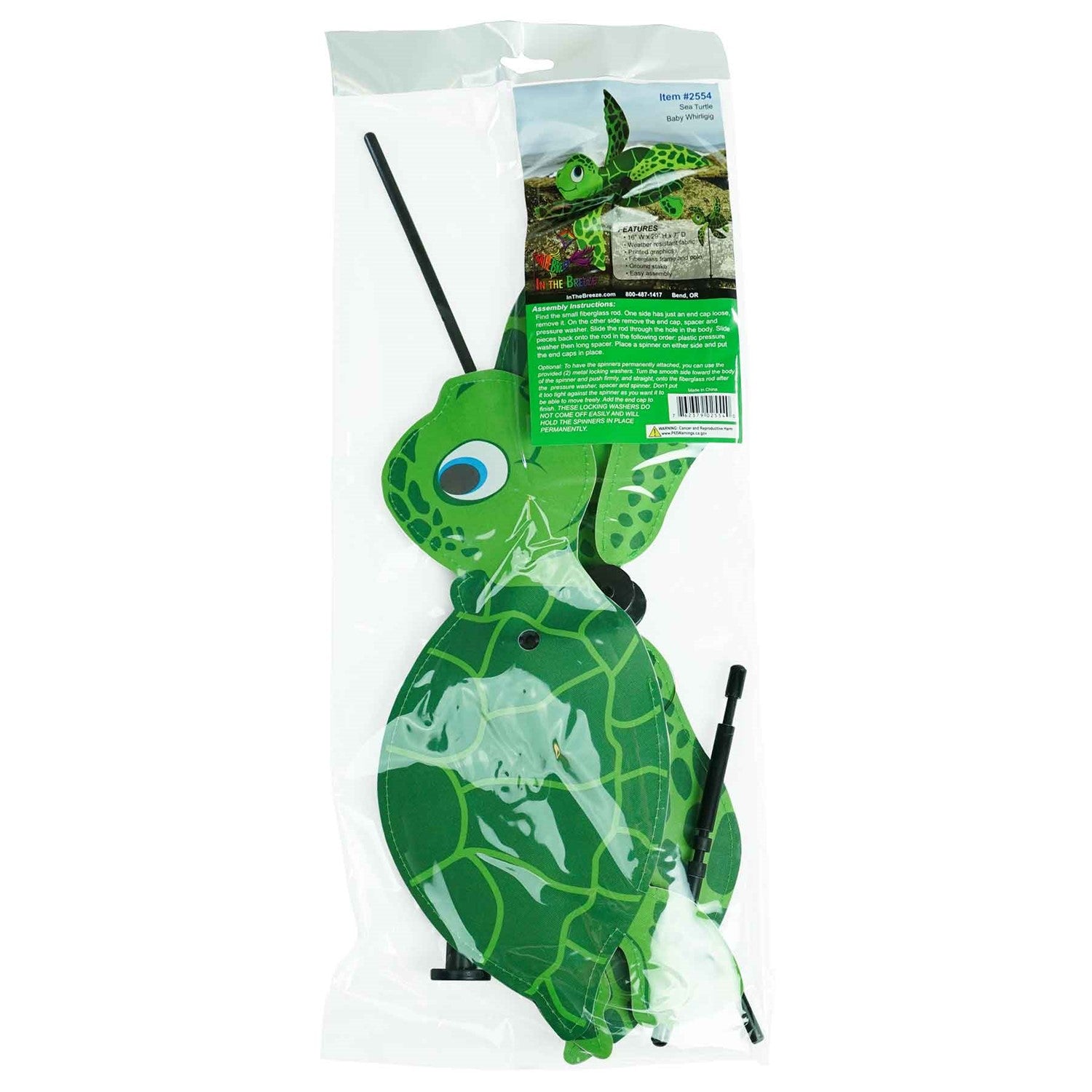 Sea Turtle Baby Whirligig in colorful design, featuring counter-rotating fins, displayed in a sunny garden setting, enhancing the outdoor atmosphere.
