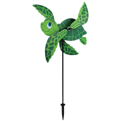 Sea Turtle Baby Whirligig in colorful design, featuring counter-rotating fins, displayed in a sunny garden setting, enhancing the outdoor atmosphere.