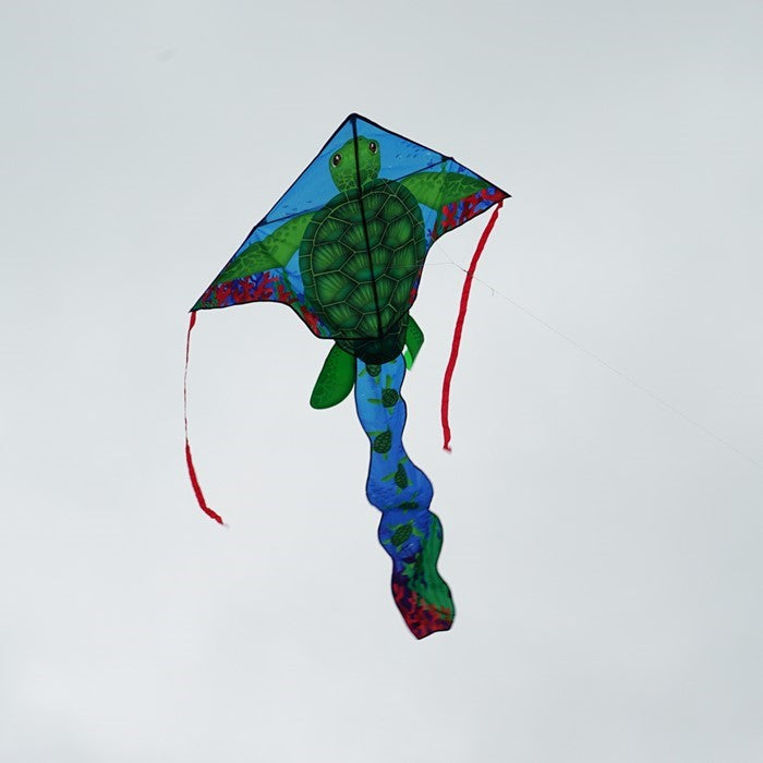 Sea Turtle 45' Fly-Hi Kite soaring in the sky, featuring a vibrant sea turtle design with colorful streamer tails attached.