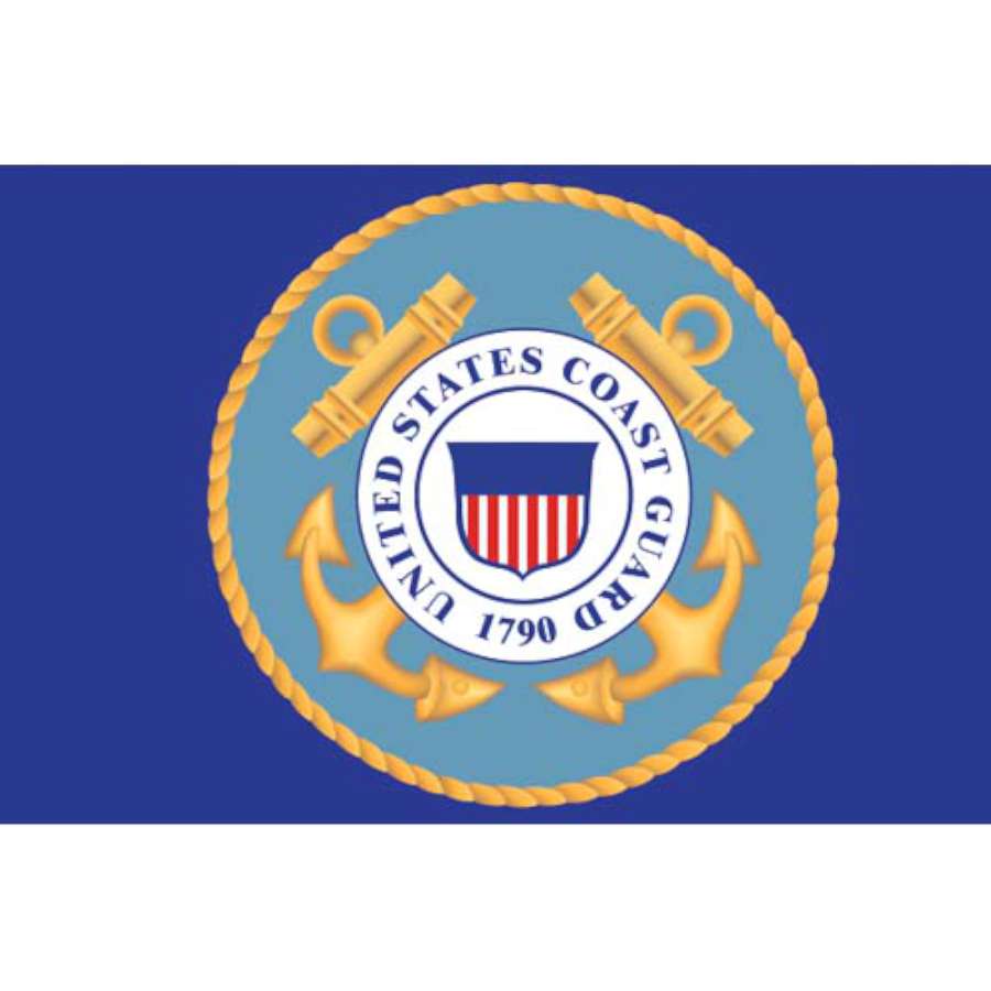 Seafarer Flag featuring Coast Guard emblem with vibrant colors displayed on a flagpole during summer in a coastal setting.