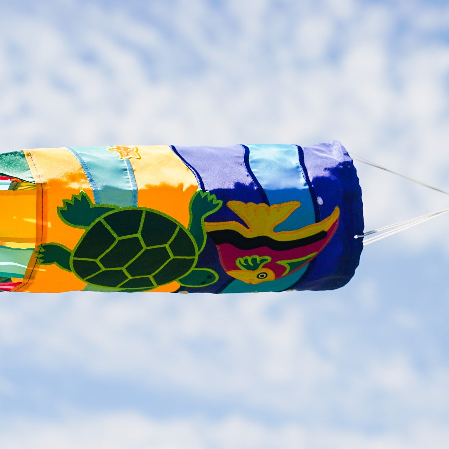 Sealife Turtle 40-inch windsock with bright colors and appliqued graphics, featuring a turtle design and fluttering tails displayed in an outdoor setting.