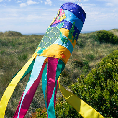 Sealife Turtle 40-inch windsock with bright colors and appliqued graphics, featuring a turtle design and fluttering tails displayed in an outdoor setting.