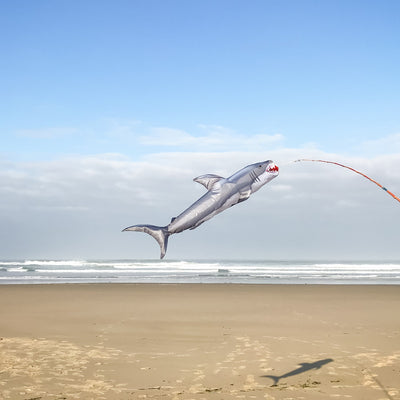 Shark 48" Fish Windsock featuring a realistic great white shark design, elegantly displayed in a backyard setting near the water.
