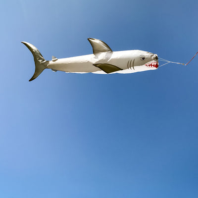 Shark 48" Fish Windsock featuring a realistic great white shark design, elegantly displayed in a backyard setting near the water.