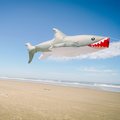 3D Shark Big Breeze WindsockTM in vibrant colors swaying in the breeze, designed for outdoor decoration and line laundry.